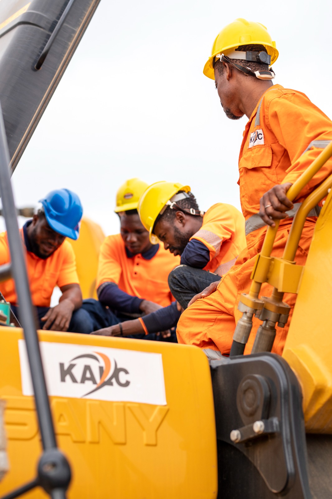 KALC crew working atop an excavator